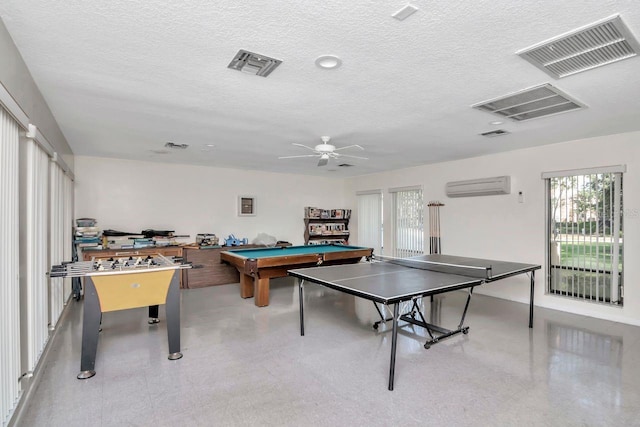 playroom with a wall mounted air conditioner, a textured ceiling, ceiling fan, and billiards