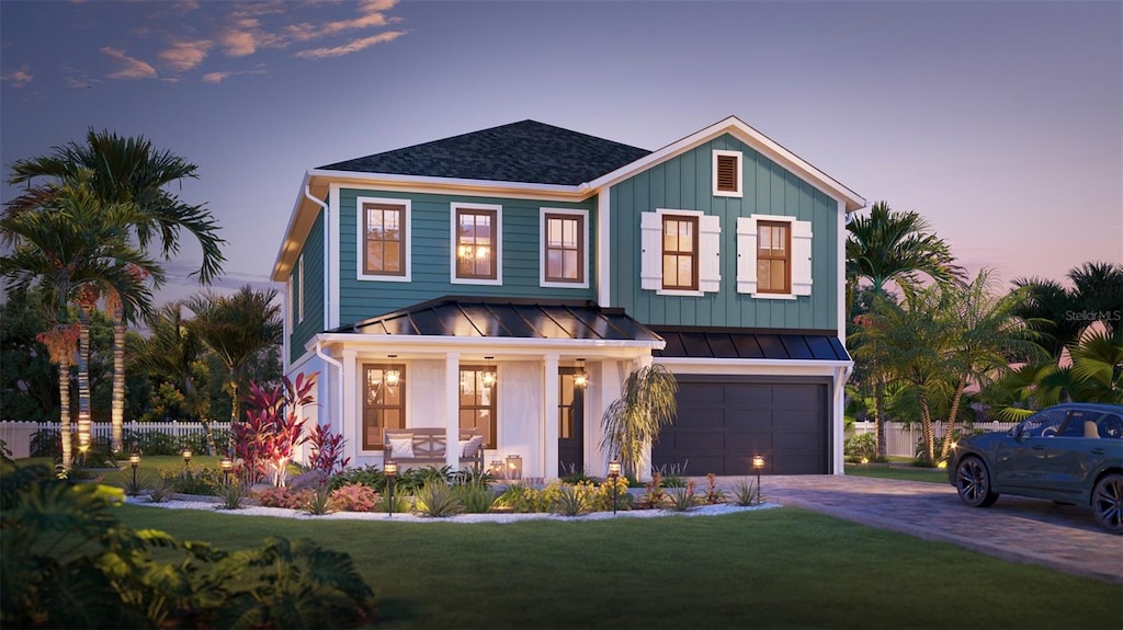 view of front of home featuring a garage and a yard