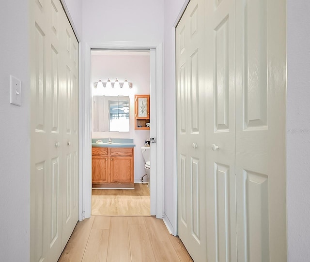 hall featuring sink and light wood-type flooring