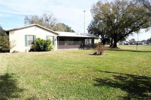 view of yard with a sunroom