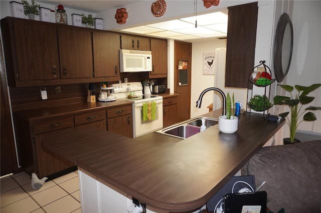 kitchen featuring white appliances, kitchen peninsula, sink, and light tile floors