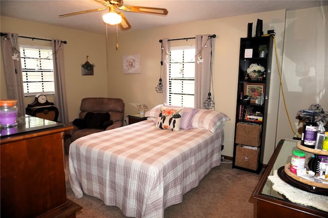 carpeted bedroom with ceiling fan and multiple windows