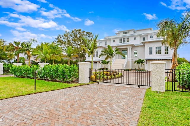 view of front of house featuring a garage and a front lawn