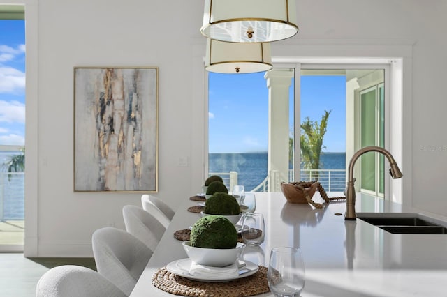 dining space featuring sink and a water view