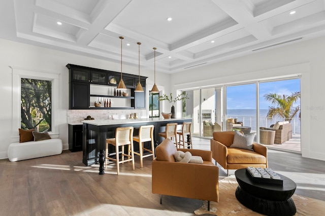 interior space featuring a water view, coffered ceiling, beamed ceiling, dark hardwood / wood-style floors, and indoor bar