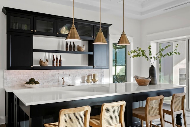 kitchen with a wealth of natural light, a breakfast bar area, and decorative light fixtures