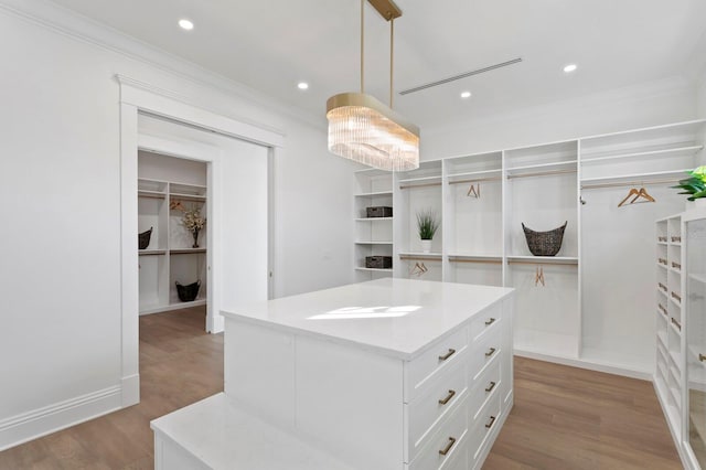 walk in closet featuring light hardwood / wood-style flooring