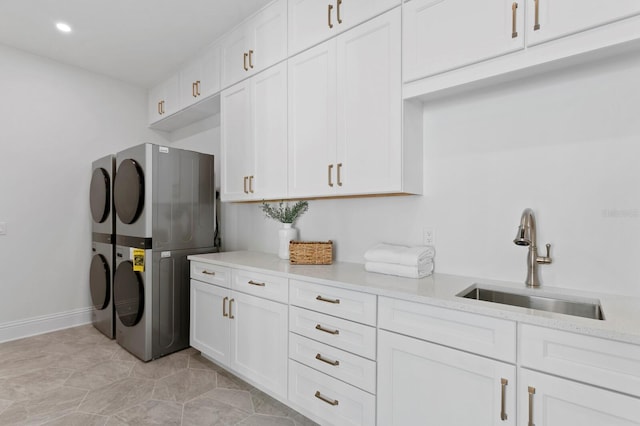 washroom with stacked washing maching and dryer, cabinets, sink, and light tile patterned floors