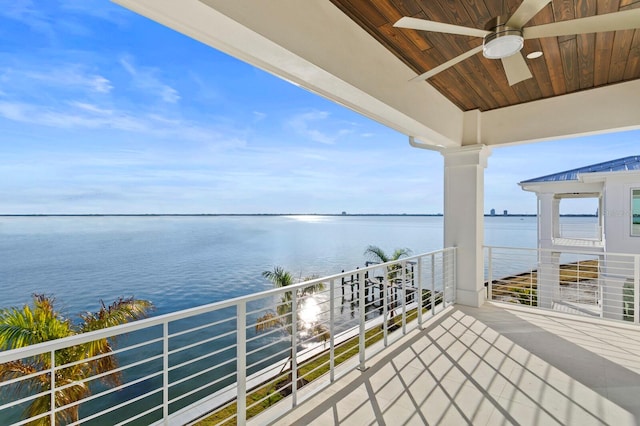 balcony with a water view and ceiling fan