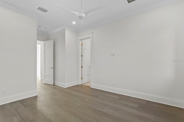 spare room with ornamental molding and dark hardwood / wood-style flooring