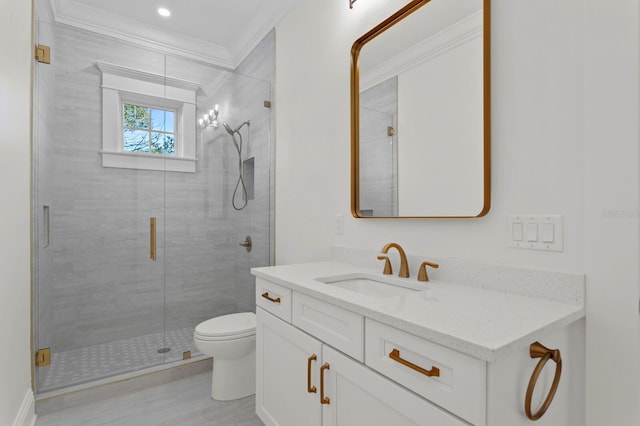 bathroom with a shower with door, vanity, toilet, and ornamental molding