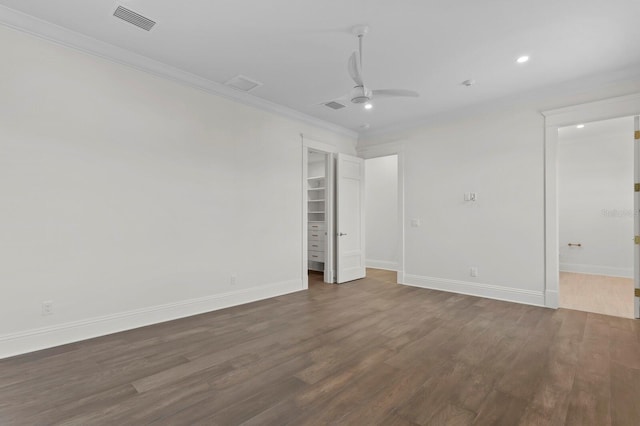 unfurnished room with dark wood-type flooring, ceiling fan, and crown molding