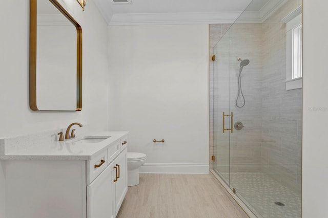 bathroom with hardwood / wood-style flooring, vanity, an enclosed shower, and ornamental molding