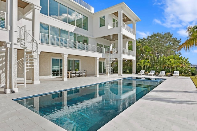 rear view of house with a patio and a balcony