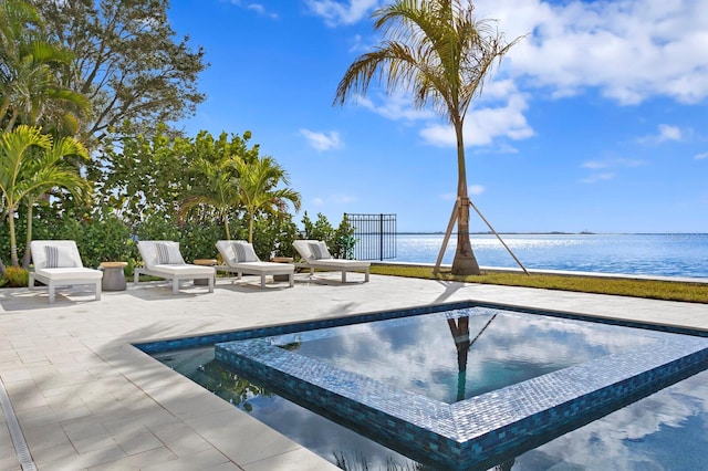 view of pool featuring a view of the beach, a water view, and a patio