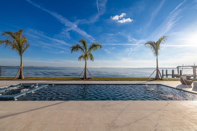 view of pool featuring a water view