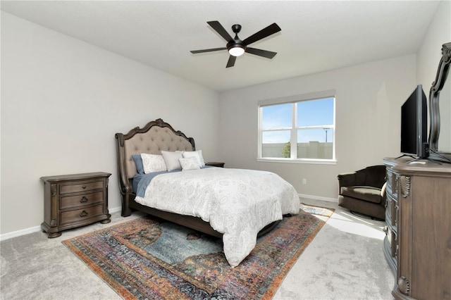 bedroom featuring light carpet and ceiling fan