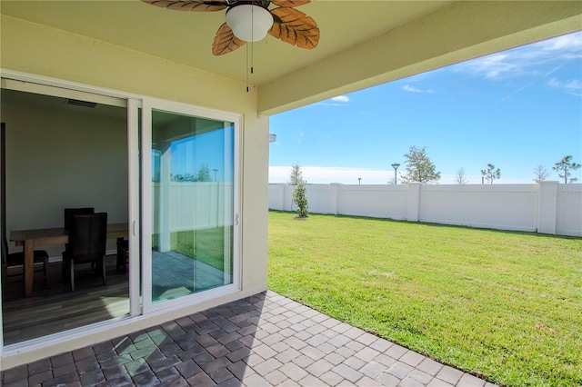 view of yard featuring a patio and ceiling fan