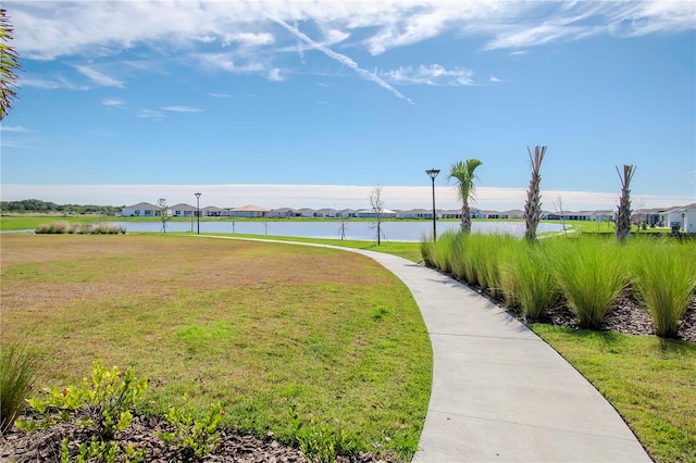 view of property's community featuring a water view and a lawn