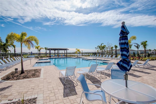 view of pool with a pergola and a patio