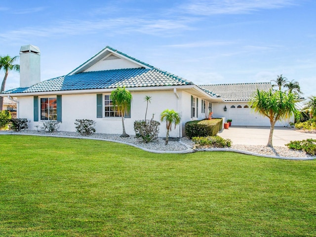 view of front facade featuring a front lawn and a garage