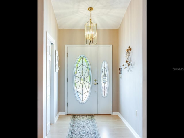 entryway with a chandelier and light wood-type flooring