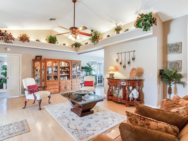 living room with high vaulted ceiling, light hardwood / wood-style floors, and ceiling fan