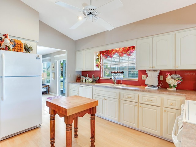 kitchen featuring white appliances, sink, ceiling fan, light hardwood / wood-style flooring, and lofted ceiling