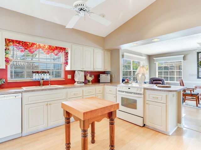 kitchen with white appliances, ceiling fan, light hardwood / wood-style flooring, white cabinetry, and lofted ceiling