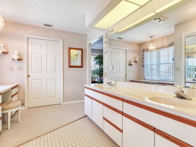 bathroom featuring vanity with extensive cabinet space, tile floors, dual sinks, an inviting chandelier, and a textured ceiling