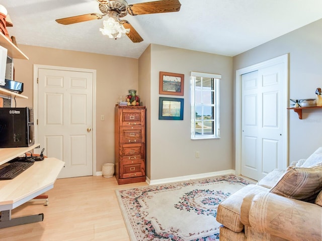 living room with ceiling fan and light wood-type flooring