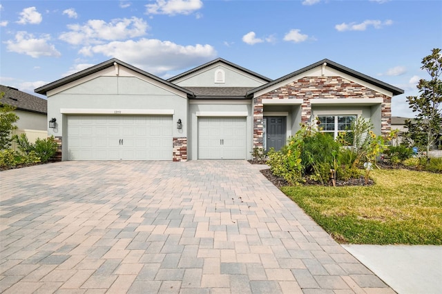 view of front of home featuring a garage and a front yard