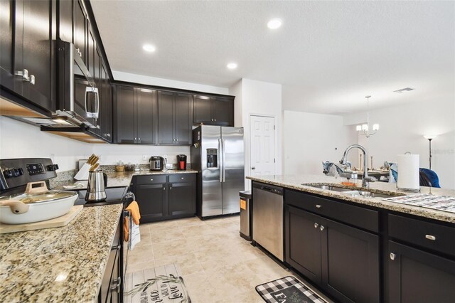 kitchen with appliances with stainless steel finishes, light tile patterned floors, light stone countertops, and sink