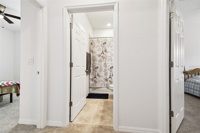 bathroom featuring ceiling fan, toilet, and tile patterned floors