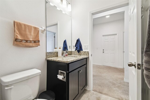 bathroom with vanity, tile patterned flooring, and toilet