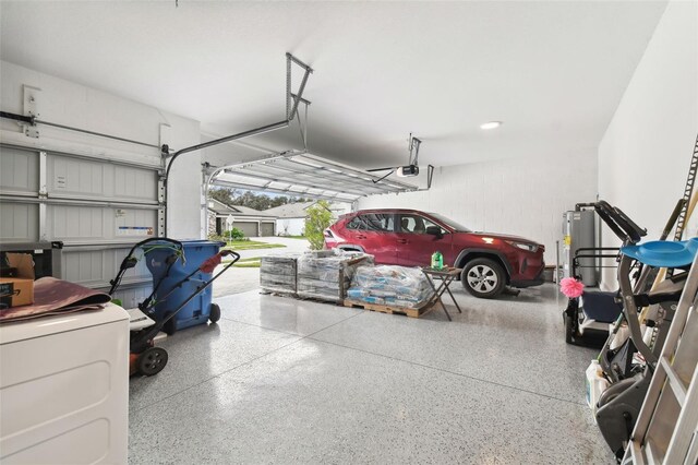 garage with washer / clothes dryer and a garage door opener