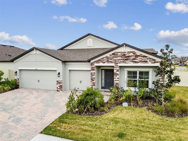 single story home featuring a garage and a front yard