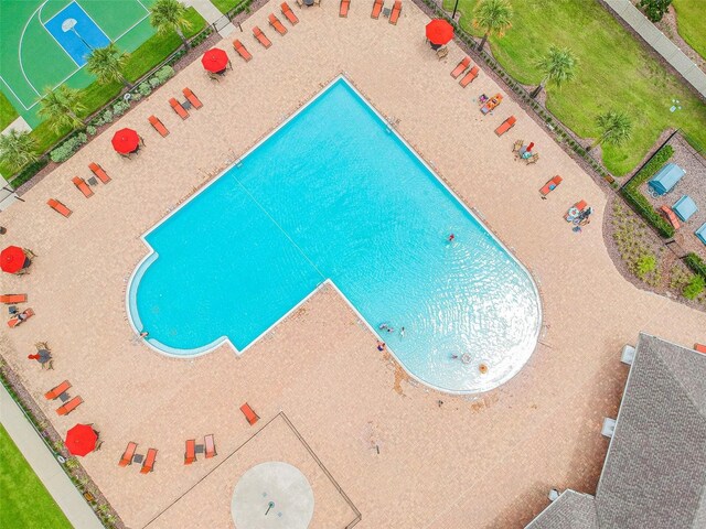 view of swimming pool featuring basketball court