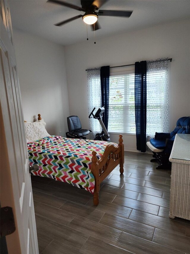 bedroom with ceiling fan and wood-type flooring