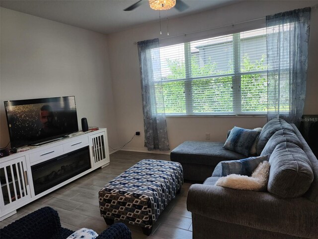 living room with dark hardwood / wood-style floors and ceiling fan