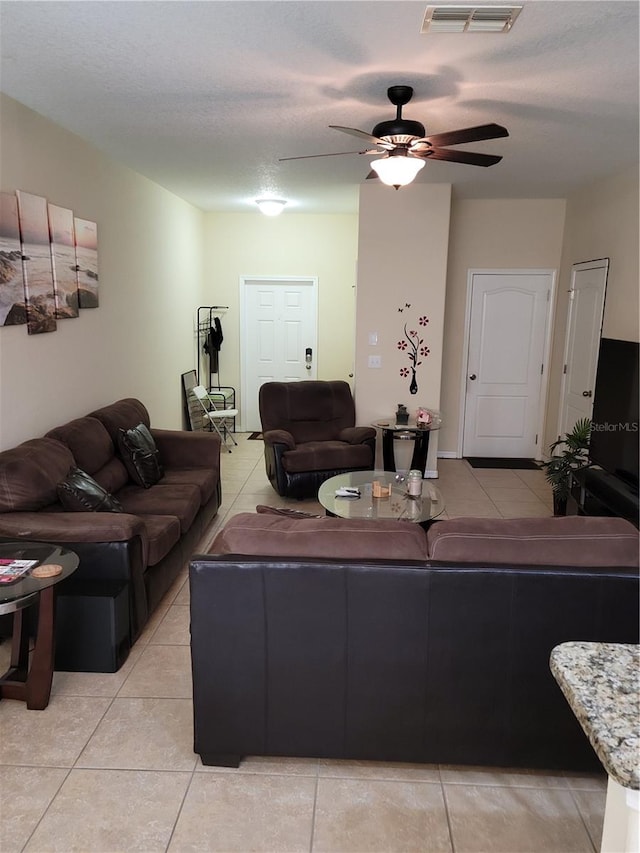 living room featuring ceiling fan and light tile floors