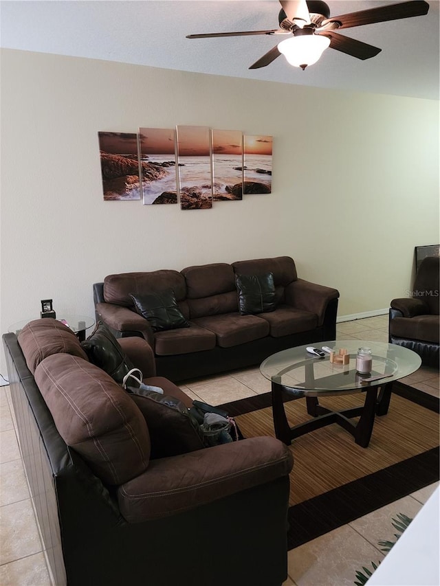 living room featuring light tile floors and ceiling fan