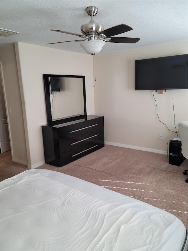 unfurnished bedroom featuring light colored carpet and ceiling fan