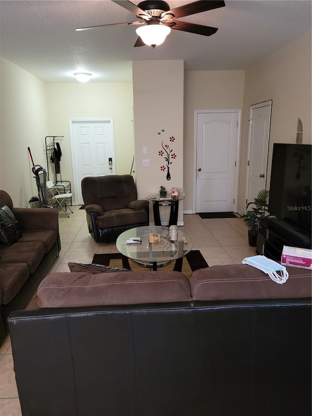 living room featuring ceiling fan and light tile floors