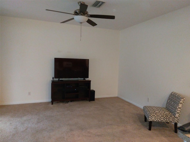 living area with ceiling fan and light colored carpet