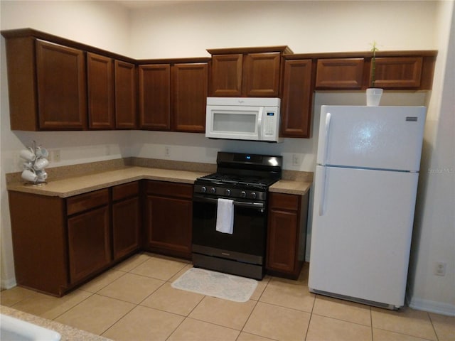 kitchen with white appliances and light tile floors