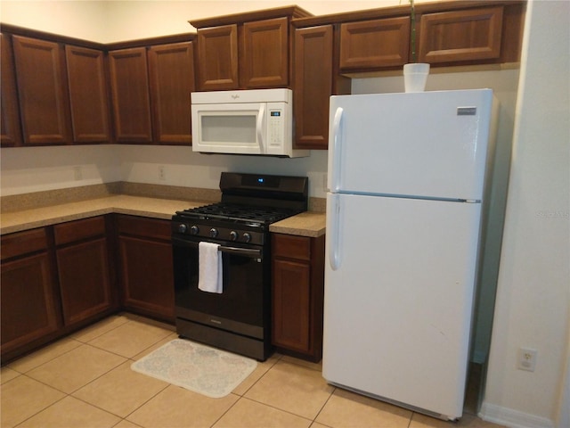 kitchen with white appliances and light tile floors