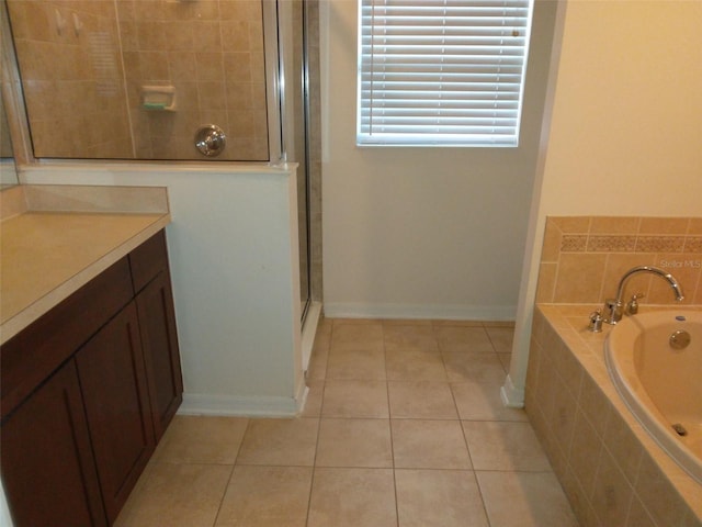 bathroom with vanity, tile flooring, and independent shower and bath