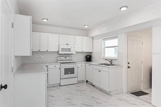 kitchen with light tile floors, tasteful backsplash, white appliances, white cabinets, and sink