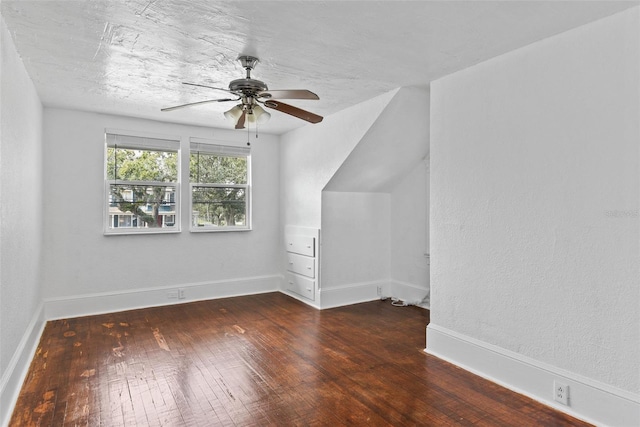 bonus room featuring ceiling fan and dark wood-type flooring